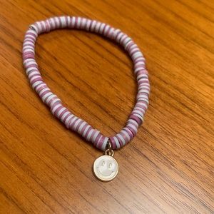 Clay bead bracket with metal smiley face charm